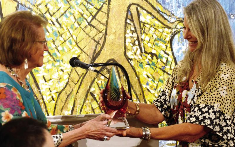 Lisa Thomas Conner, daughter of artist Steffen Thomas (left), presented a Charlie Bonner Award for Advancing Art Education to retired MCES art teacher Laura Rice. (IAN TOCHER/Staff)