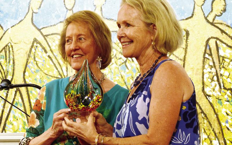 Retired MCMS art teacher Marjean Meadow (right) received a Charlie Bonner Award for Advancing Art Education from Lisa Thomas Conner. (IAN TOCHER/Staff)