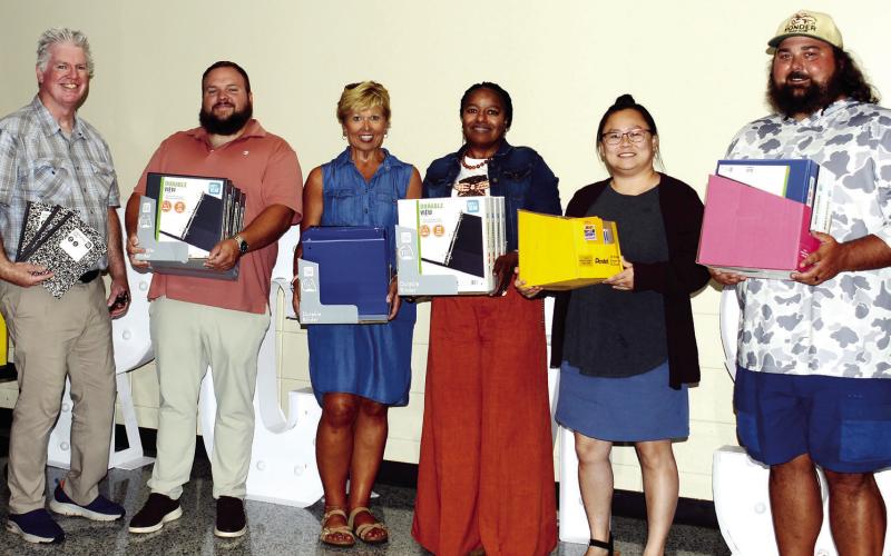 L-R: Leadership Putnam’s Ian Tocher, Justin Hadden, and Diane Carter presented several cases of paper and other school supplies to Putnam County Middle School Principal Dr. Monconia Browner and teacher Ruth Bryant, with donation organizer AJ Nugent. CONTRIBUTED