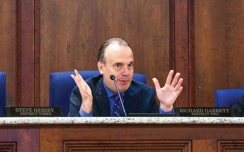 District 2 Commissioner Richard Garrett makes a point during the Aug. 7 meeting, with District 3’s Steve Hersey (left) and Tom McElhenney of District 1 listening. District 4 Commissioner Jeff Wooten was absent. IAN TOCHER/Staff