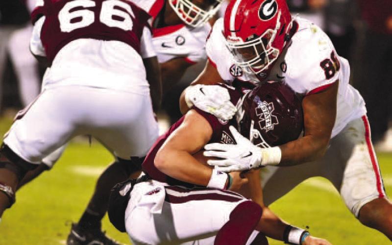 Georgia defensive linemen Jalen Carter (88) sacks Mississippi State quarterback Will Rogers during Saturday’s game in Starkville, Miss.