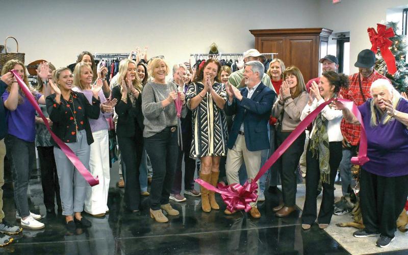 Well-wishers cheer as the ribbon falls to officially open Second Chance Boutique at 939 Greensboro Rd., Eatonton. Proceeds from the upscale thrift store will benefit Circle of Love, a long-running domestic violence shelter in Greene County. IAN TOCHER/Staff