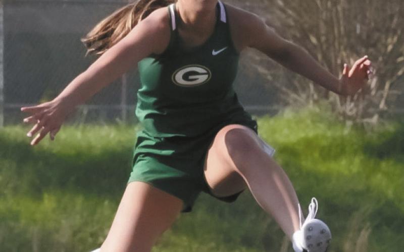 London Darden glides over a hurdle during the 100-meter hurdle race at a meet earlier this season. LANCE MCCURLEY/Staff