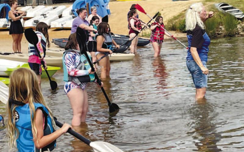 George Craig (right) teaches proper hand position and movements for paddling. CONTRIBUTED