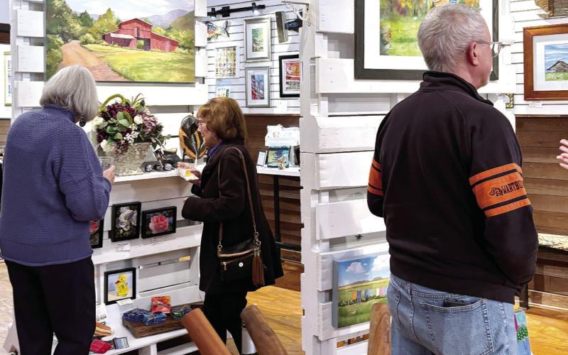 People enjoy the exhibit on Jan. 11 at the studio in downtown Eatonton. EMMA CLAUSE/Staff