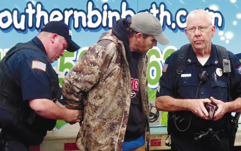 Eatonton Police Department officers handcuff David Emanuel Garcia, 39, of Macon.