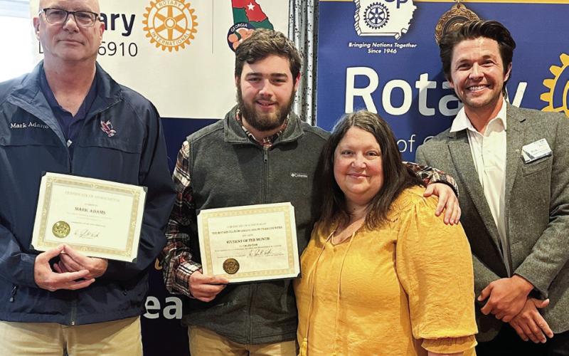 Putnam County High School November student of the month Caleb Cook (center) with Mark Adam (left), Crystal Cook, and Rotarian Dr. Tyler Franks. CONTRIBUTED