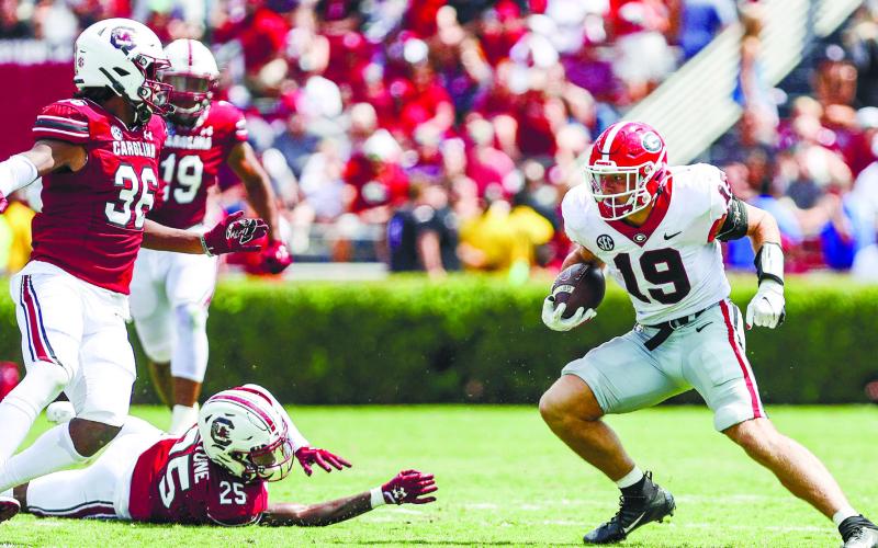 Georgia tight end Brock Bowers evades defenders on a touchdown run against the South Carolina Gamecocks in Columbia, South Carolina, Saturday. Bowers had two receiving touchdowns and one on the ground. ADAM WALSH/UGA Athletics