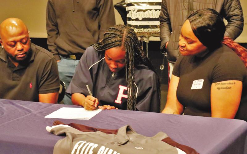 Robertson signs her letter of intent to play at Paine College. ARELLA CASH/Staff