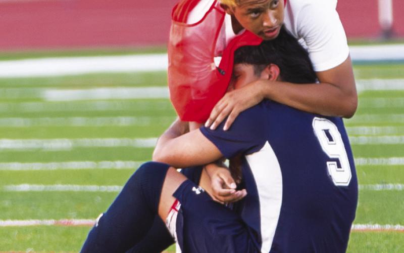 Putnam County’s Jonathan Acostas (9), who scored the War Eagles’ lone goal in their Elite Eight matchup, is comforted by a teammate following the loss to Barrow Arts &amp;amp; Sciences Academy. SKYLA MORRIS/Staff