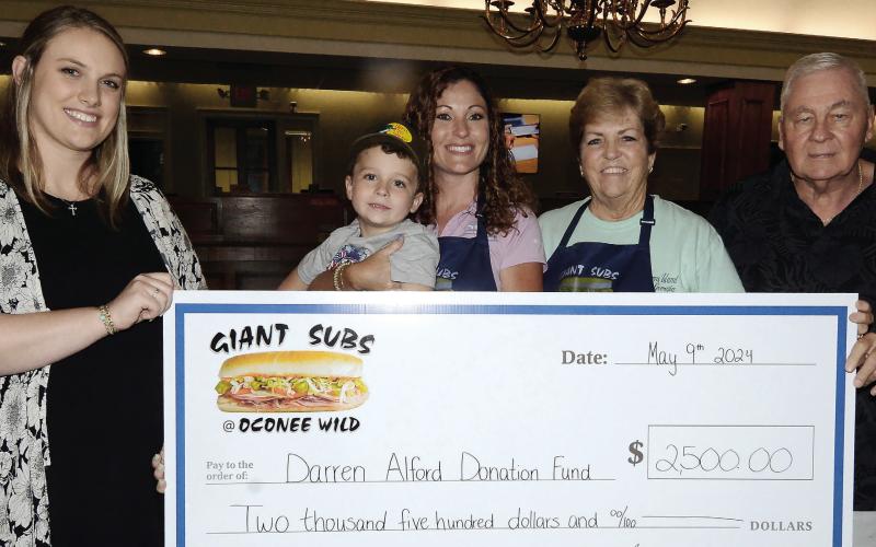 L-R: Rebecca Wilson, daughter of Darren Alford; Barrett and Kierston Tuel, owner of Giant Subs and Oconee Wild Watersports; Cathy Tuel, manager of Giant Subs, and Terry Tuel. IAN TOCHER/Staff