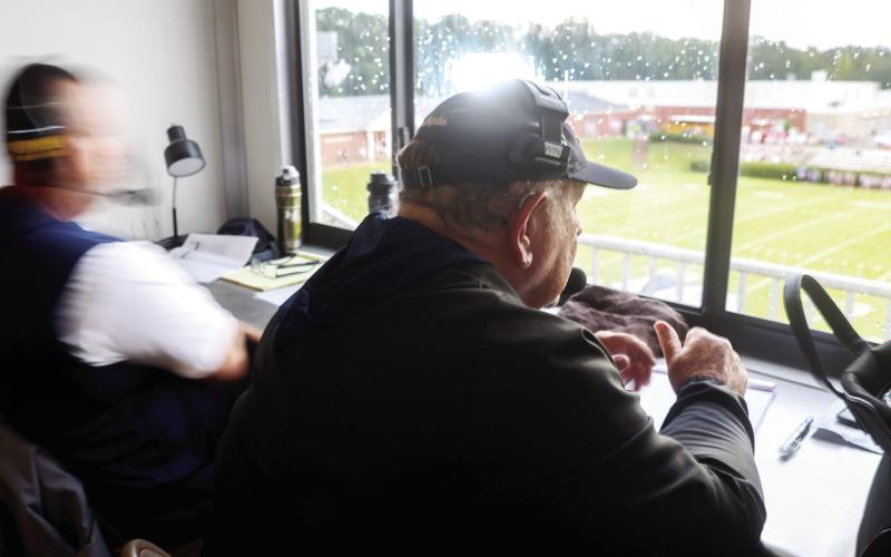 Putnam County assistant coach Charlie Winslette sits in the visiting coaches box at Morgan County High School in Madison, on Aug. 22. Winslette has been coaching high school football for 52 years. Abbey Cutrer/AJC