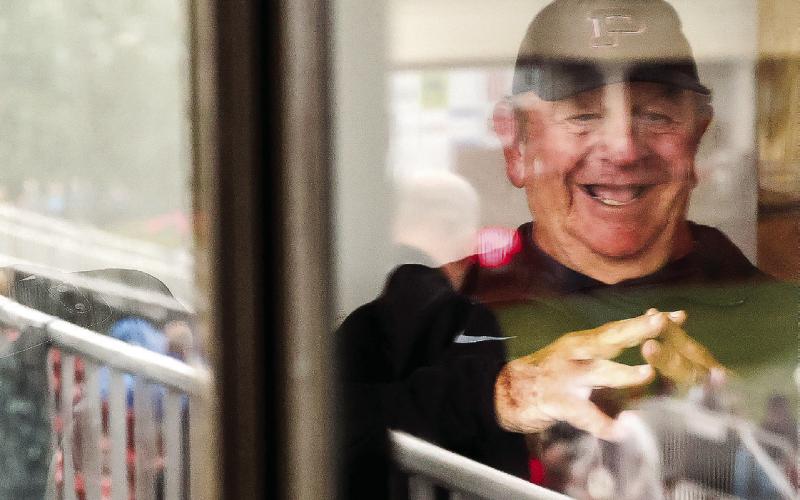 Winslette sits in the visiting coaches box at MCHS. “There’s nothing any more exciting than a high school football Friday night,” he says. Abbey Cutrer/AJC