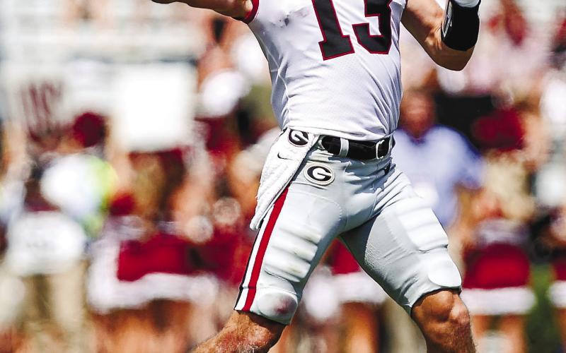 Georgia quarterback Stetson Bennett (13) drops back for a pass during its SEC opener with South Carolina Saturday. Bennett led the team in both passing and rushing yards. ADAM WALSH/UGA Athletics