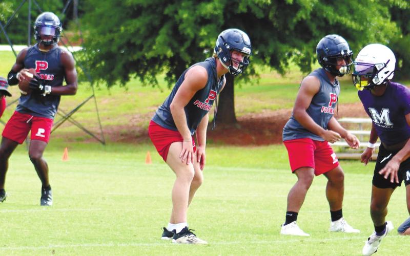Jalon Kilgore takes the snap with Seth Boyer in protection. ARELLA CASH/Staff