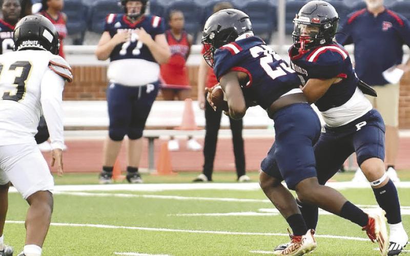 War Eagles’ quarterback Branan Griffin hands the ball off to junior running back Cory Foster. BRENDAN KOERNER/Staff