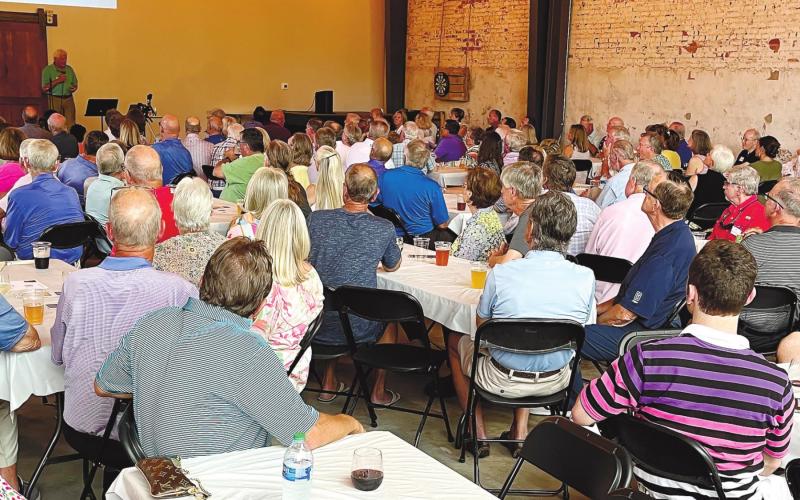 The name change to Neighbors Helping Neighbors was announced Tuesday night at a membership meeting held at Oconee Brewing Company. Some recipients spoke to the group about how the organization has helped improve their lives. MARK ENGEL/Staff