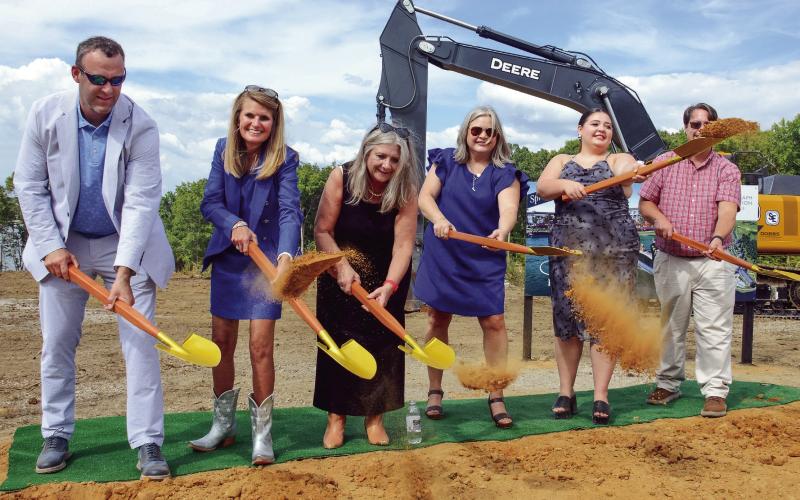 Josh and Lauren Sprayberry (left) were joined by family members in a ceremonial groundbreaking last Thursday for the Len Resort &amp;amp; Residences, slated for completion in May 2026 on the Putnam County shores of Lake Oconee. IAN TOCHER/Staff