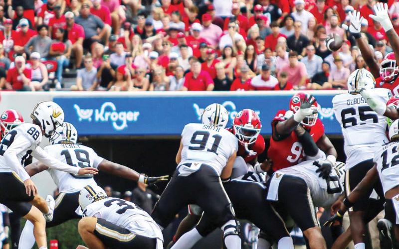 Georgia defensive linemen playing on special teams got tall to block an attempted field goal by Vanderbilt. TREY NORRIS/Staff