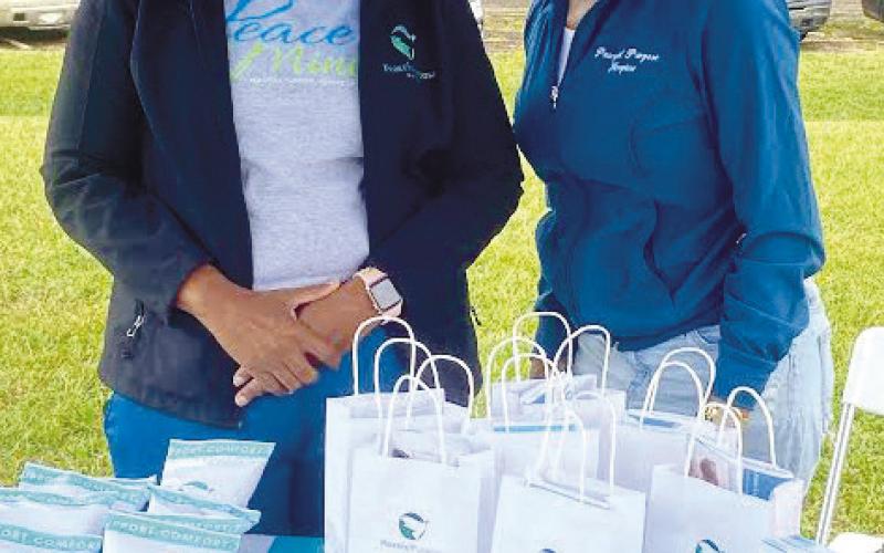 Melissa Williams and Kim Farley pose at their booth for Peaceful Purpose Hospice of Georgia. CONTRIBUTED