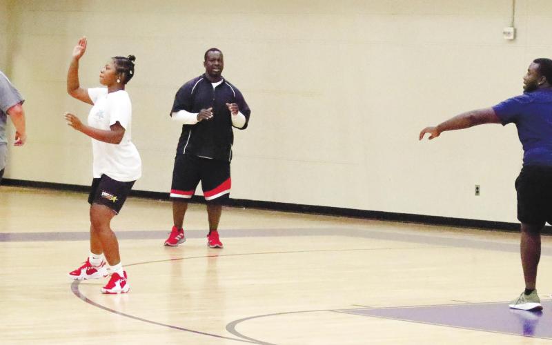 Coach Arrington has Tytianna Little and Ti Davis run 2-on-2 practice with Assistant Coach Royal and David Levester.