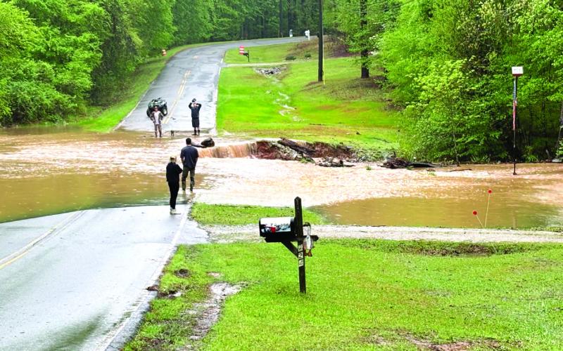 County officials assess West Riverbend Drive conditions Monday afternoon. CONTRIBUTED