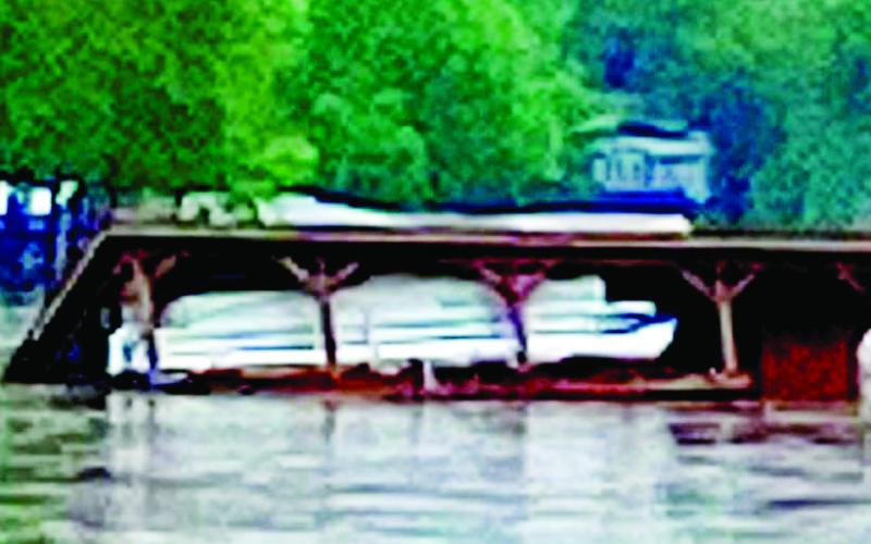 A pontoon boat floats into Lake Sinclair along with its boathouse after Monday’s heavy rainfall. CONTRIBUTED