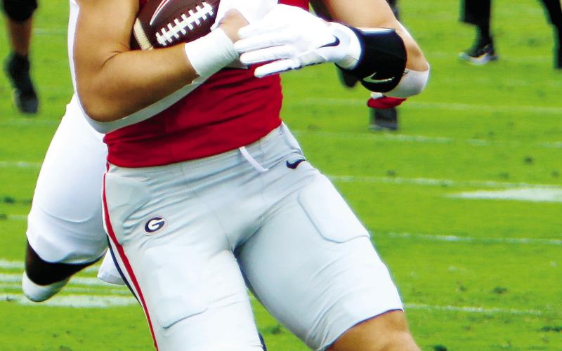 Georgia tight end Lawson Luckie hauls in a pass and runs for yards after the catch during a win over Auburn. LANCE McCURLEY/Staff