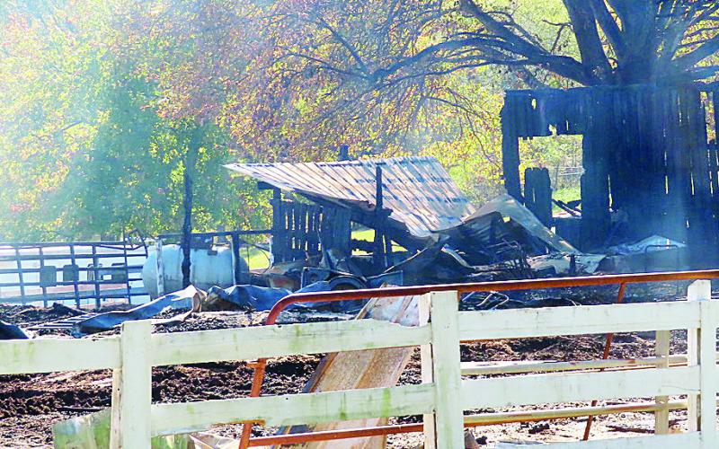 Smoldering ashes and rubble are all that’s left of a horse barn after a fire at Manley Arena last week. LYNN HOBBS/Staff