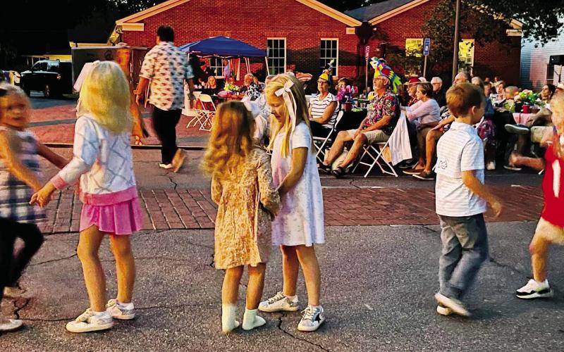 Kids dance near the plaza stairs during a previous outdoor performance at The Plaza Arts Center. (CONTRIBUTED)