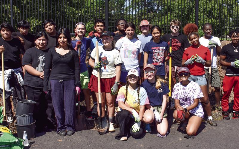 Hannah Erickson (center, kneeling) led an eager PCHS Beta Club crew in a major planting project to help beautify Jimmy Davis Park while eventually providing added privacy to nearby neighbors. IAN TOCHER/Staff