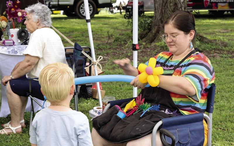 Whitney Gutierrez made animal balloons for all the children who selected their own colors for their animals. LEIGH LOFGREN/Staff