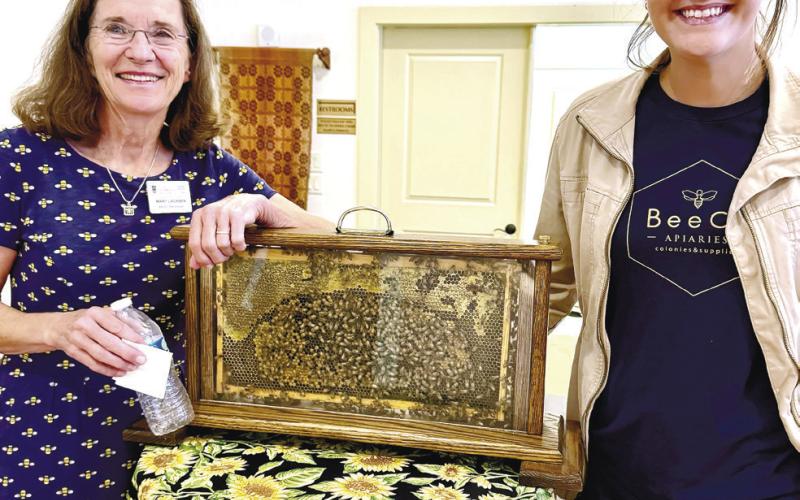 BeeCo Apiaries’ Mary Lacksen (left) and her daughter-in-law Caroline Lacksen exhibit a live honeybee hive during their visit to Eatonton’s Old School History Museum last Sunday. CONTRIBUTED