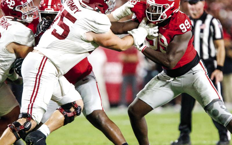 Georgia defensive lineman Joseph Jonah-Ajonye (99) tries to get around Alabama offensive lineman Wilkin Formby (75) and make a tackle in the backfield. LANCE McCURLEY/Staff