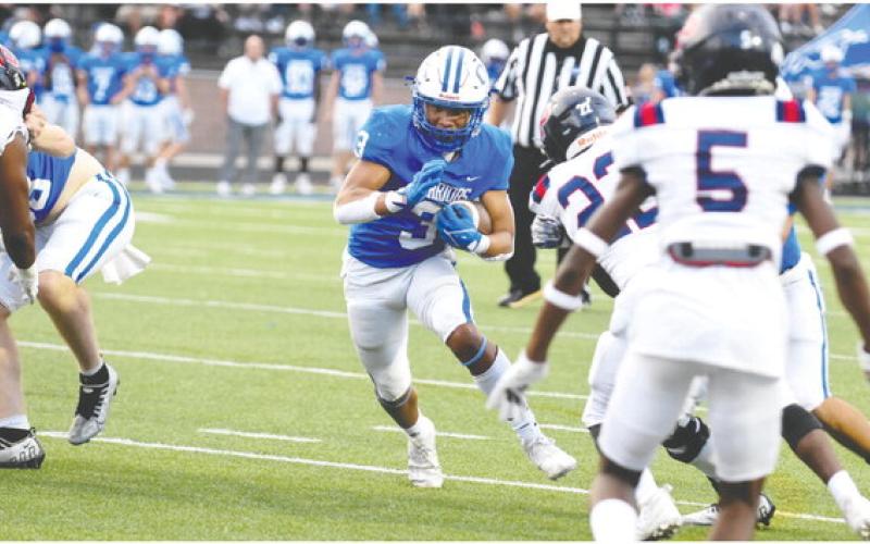 Oconee County running back Caiden Wood (3) runs through a hole in the Putnam County defense in Friday’s win. LANCE MCCURLEY/Staff