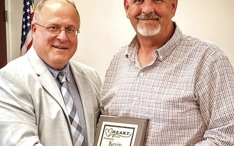Assistant Superintendent Scott Sauls presents Kevin Thompson with the H.E.A.R.T. Award. LINDSEY RICKMAN/PCCSS