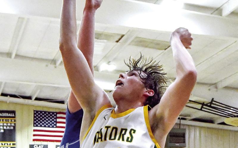 Lake Ferman attempts a put-back shot for the Gators over a CFCA defender. IAN TOCHER/Staff