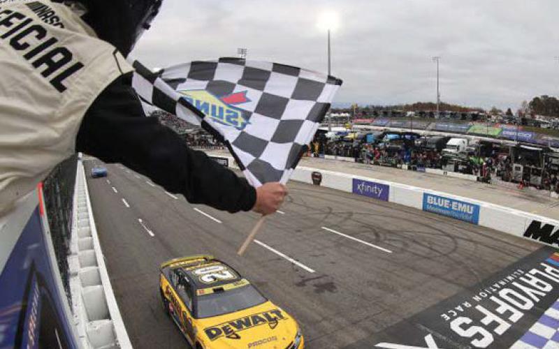 Christopher Bell, driver of the No. 20 DeWalt Toyota, takes the checkered flag to win the Cup Series Xfinity 500 at Martinsville Speedway Sunday. (Mike Mulholland/Getty Images)