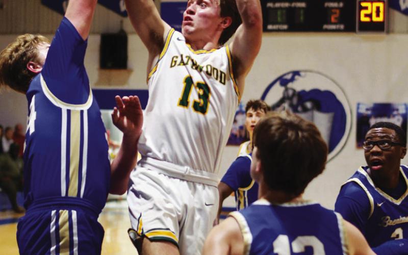 Kaden Keiser is surrounded by War Eagles as he goes up for a shot Thursday night in Macon.