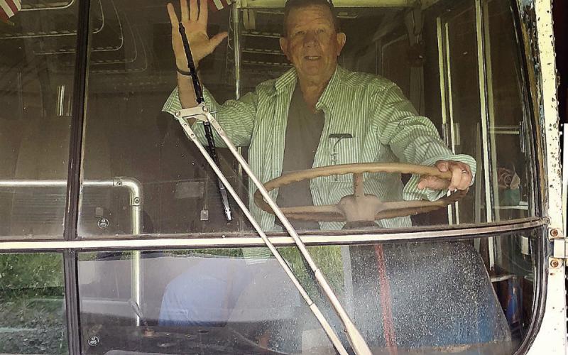 T.M. Brown sits in the driver seat of Fred and Kay Wallace’s bus that serves as the inspiration to the next installment in his Shiloh mystery series. CONTRIBUTED