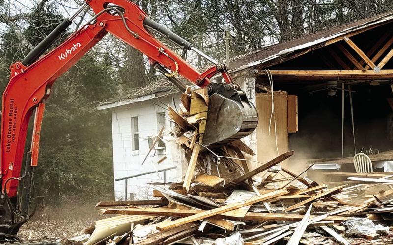 A demolition worker tears into Rooty Creek Primitive Baptist Church last week, readying it for a trip to a landfill. IAN TOCHER/Staff