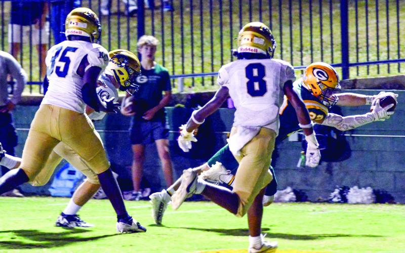 Gatewood running back Hunter Johnson (22) dives into the end zone and scores a touchdown during a game last season. IAN TOCHER/Staff