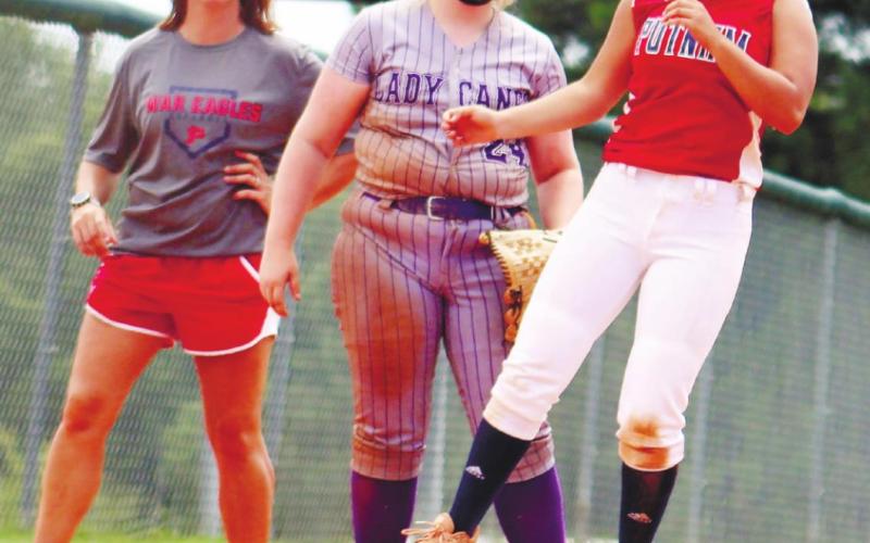 Eva Espin is safe at third base as Coach Jones watches.
