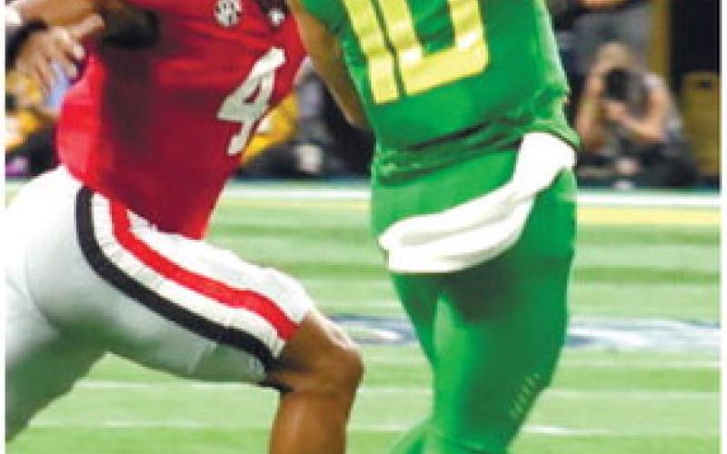 Senior linebacker Nolan Smith (4) chases after Ducks’ quarterback Bo Nix (10) as he scrambles out of the pocket and toward the right sideline. BRENDAN KOERNER/Staff