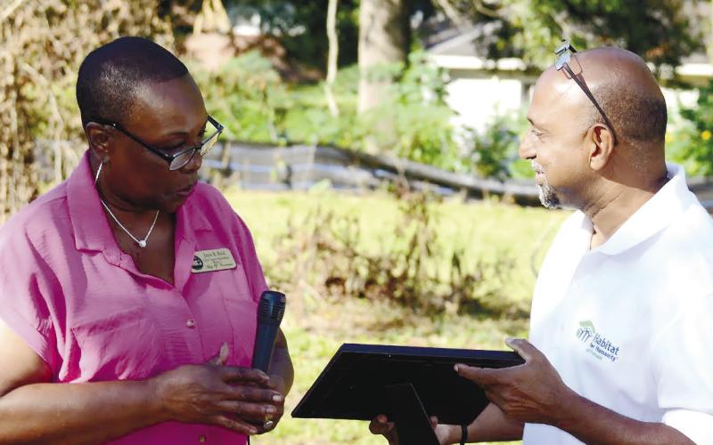 Eatonton City Councilmember Janie Reid read and presented an official city proclamation supporting World Habitat Day to HFH Putnam Executive Director Murali Thirumal.