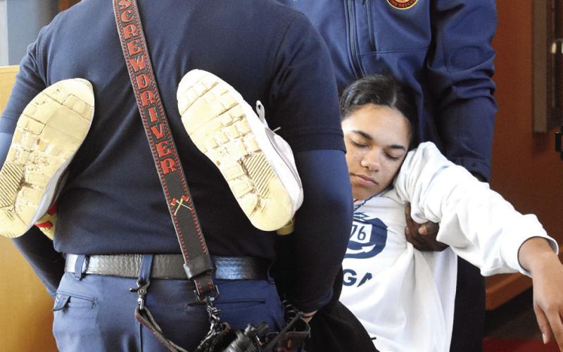 Baldwin County Fire Rescue carries a “deceased” student out of the building. BAILEY BALLARD/Staff