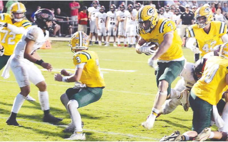 With Jackson Hewatt (3) providing cover, Evan Bennett (7) makes his way across the goal line for Gatewood's first touchdown last Friday night in a 17-8 win over Briarwood. IAN TOCHER/STAFF