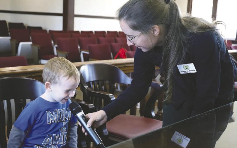 Deputy Clerk Marlie Griffin helps a young man address the court. IAN TOCHER/Staff