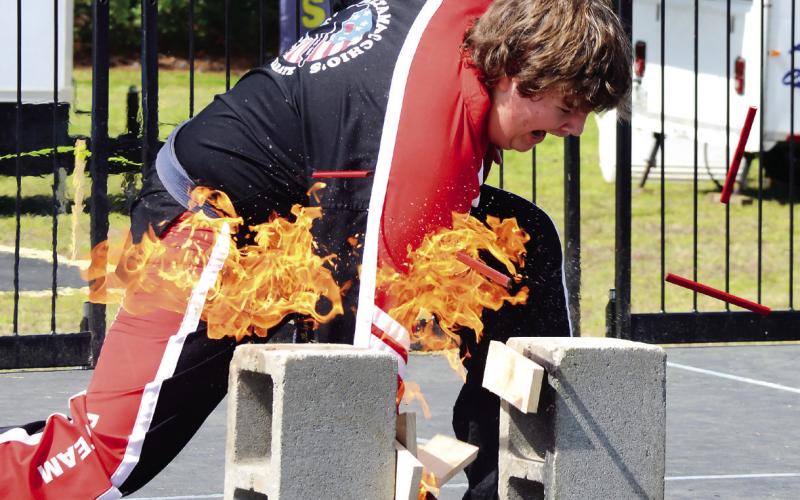 A member of Saltamacchio Karate wowed the crowd by breaking three flaming boards with one strike. IAN TOCHER/Staff