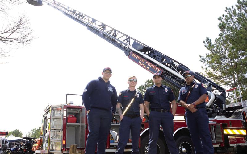 Putnam County firefighters (l-r) Dallas Dempsey, Zach Nagorski, Sydney Columbus, and Devin Morris had the department’s new ladder truck on full display at The Big Event. IAN TOCHER/Staff
